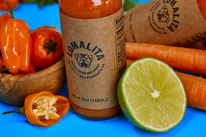 Lomalita habanero hot sauce bottle with lime and carrot